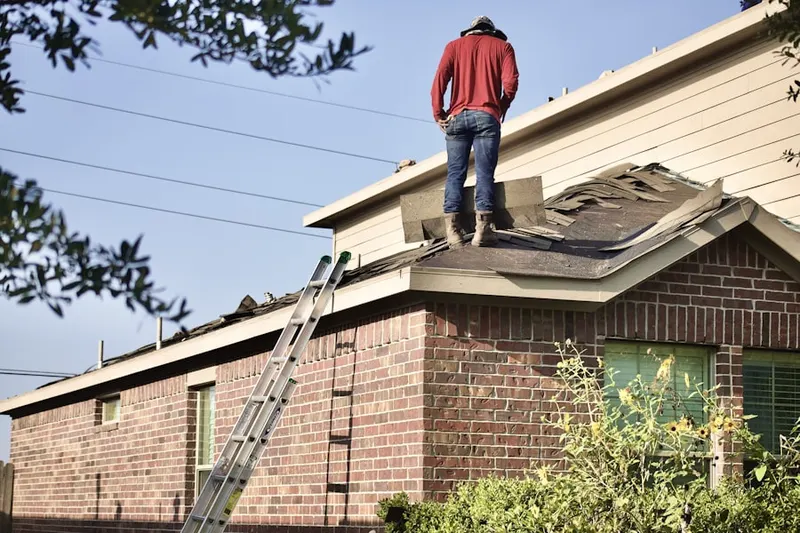 Professional roofer working on a residential roof in Metro East
